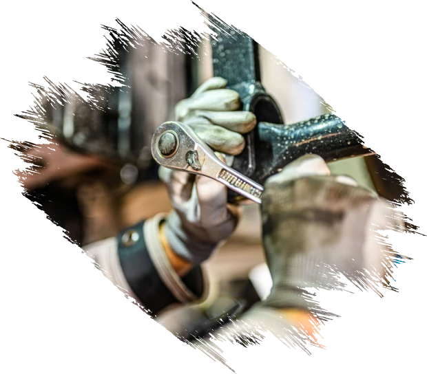 Gloved hands fixing machinery